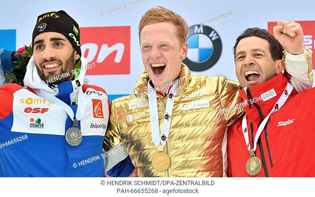 Second placed Martin Fourcade (L-R) of France, winner Johannes Thingnes Boe of Norway and third placed Ole Einar Bjoerndalen of Norway celebrate on the podium...
