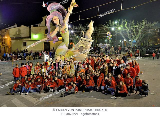 La Font Fallas group in front of a Falla, a papier-mâché figure, at the Falles or Fallas spring festival, Pego, Province of Alicante, Spain