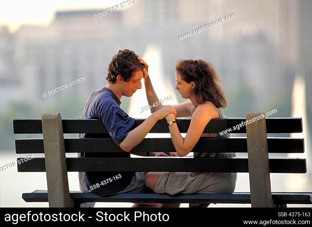 Couple Having a Serious Conversation on Park Bench