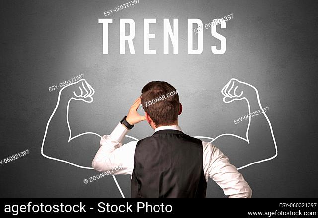 Rear view of a businessman with TRENDS inscription, powerfull business concept
