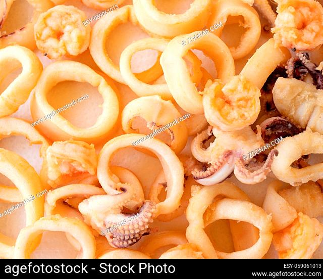 fried squids or octopus (calamari) and prawns, isolated on white background