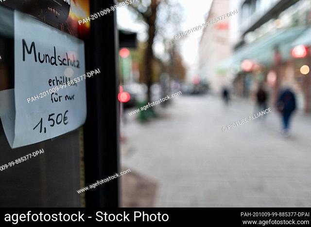 09 October 2020, North Rhine-Westphalia, Duesseldorf: A sign on Königsallee says ""Mouthguard available"". The corona pandemic is increasingly becoming a...