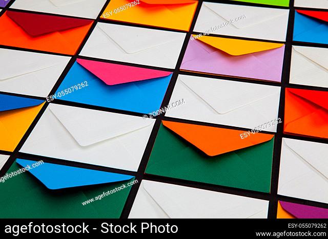 Composition with white and colored envelopes on the table. The photo suitable for various holidays and anniversaries