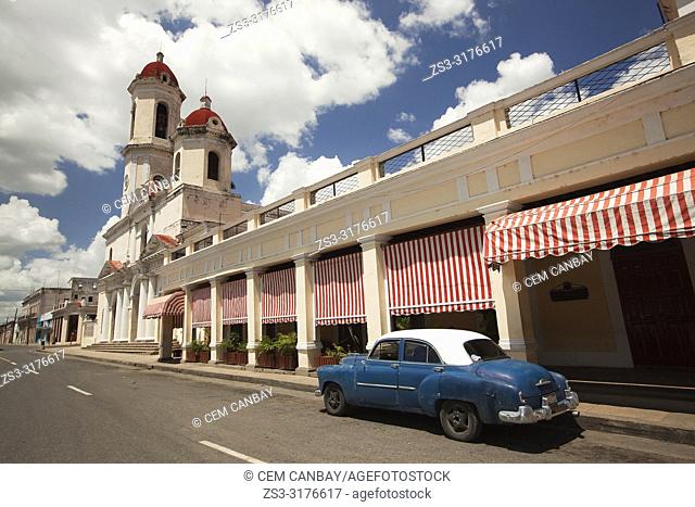 Old American car parked at the rstreet side in front of the Purisima Concepcion Cathedral in Jose Marti Park, Cienfuegos, Cuba, Central America