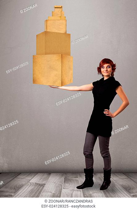 Young lady holding a set of brown cardboard boxes