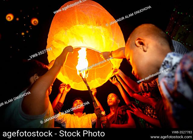 Bangladesh - October 13, 2019: Little Monks release floating (flying) paper lanterns annually at Ujani Para Buddhist Temple in Bandarban, Bangladesh