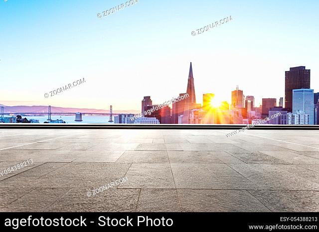 cityscape of san francisco at sunrise from empty brick floor