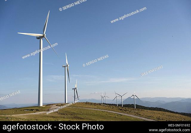 Tall wind turbines under sky