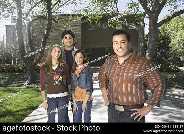 Father and children standing in driveway