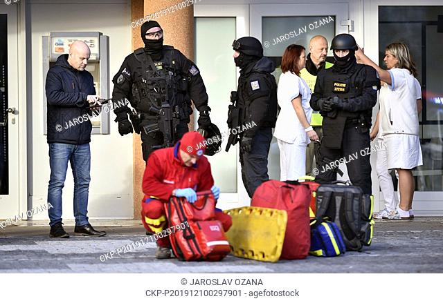 Policemen and paramedic are seen in front of the Ostrava Teaching Hospital, where six persons died after shooting on Tuesday, Dec. 10, 2019