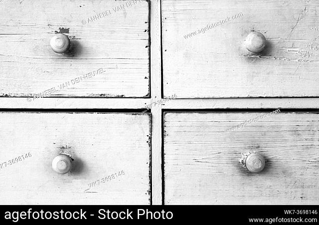 Furniture detail shot of vintage old white wooden chest of drawers background texture retro
