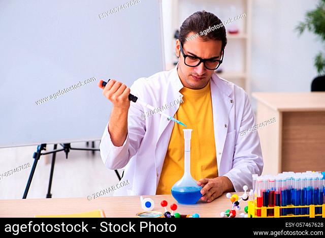 Young chemist teacher in the classroom