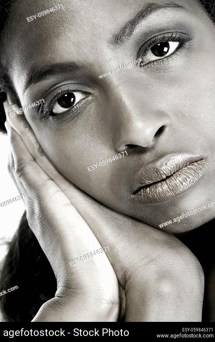 A beauty portrait taken from an african model in the studio resting on her hands