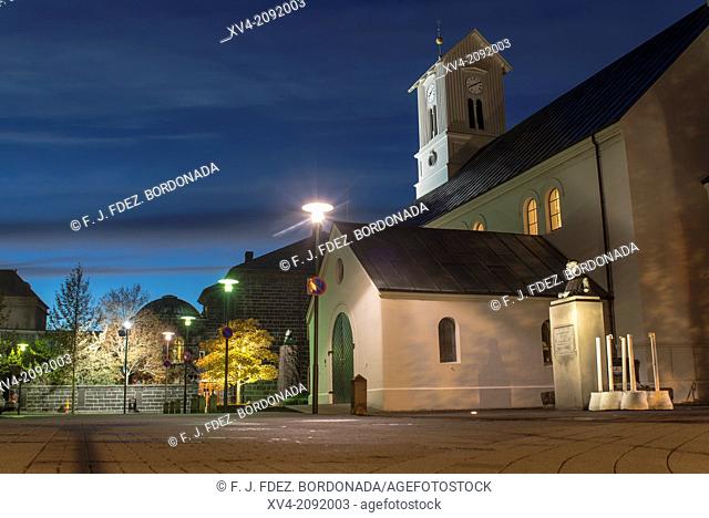 Iluminated church Domkirkjan in Reykjavik old town, city centre by night. Iceland