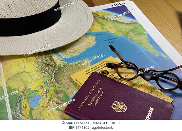 Planning a trip to Africa, historical reading glasses, passport and vaccination record