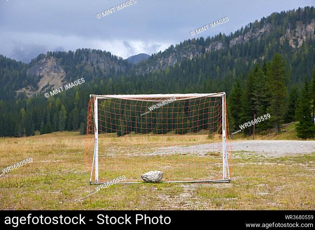 Soccer goal and a flat field in a valley in the Dolomites