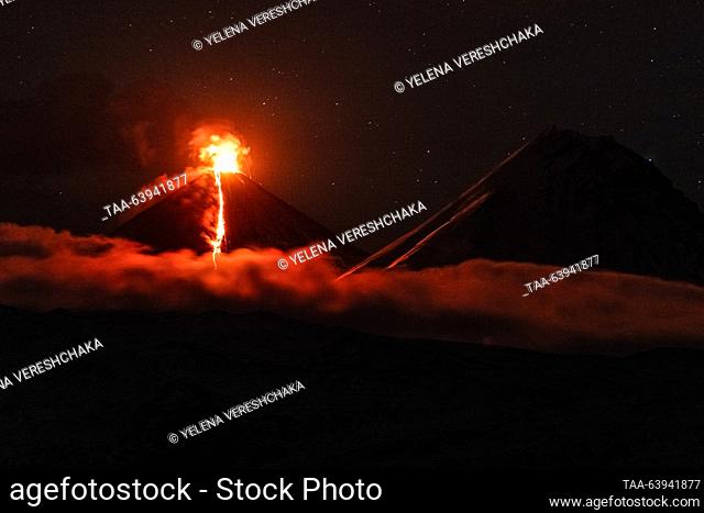 RUSSIA, KAMCHATKA REGION - OCTOBER 24, 2023: A view of Kamen dormant stratovolcano and an erupting Klyuchevskaya Sopka (Klyuchevskoi) active stratovolcano