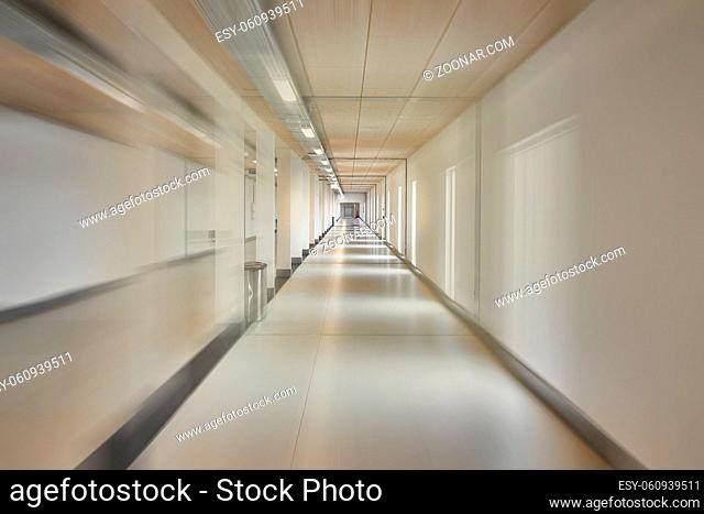 Plain corridor in a modern building rushing across with motion blur