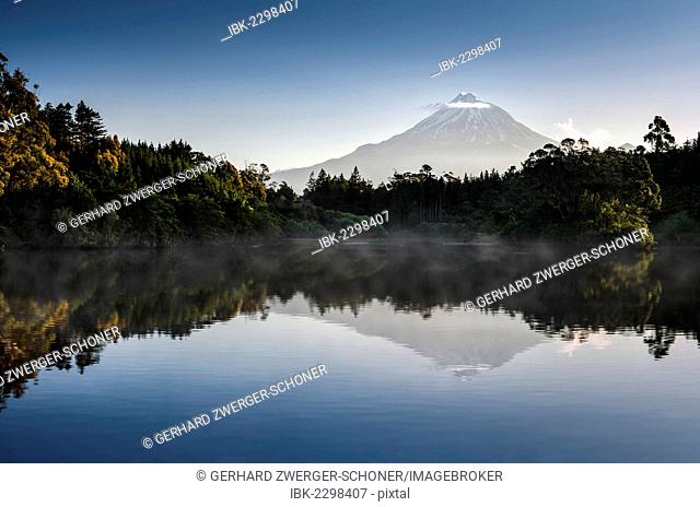 Currently inactive volcano, Mt Egmont, Mt Taranaki, reflections in Lake Mangamahoe reservoir, dam, North Island, New Zealand