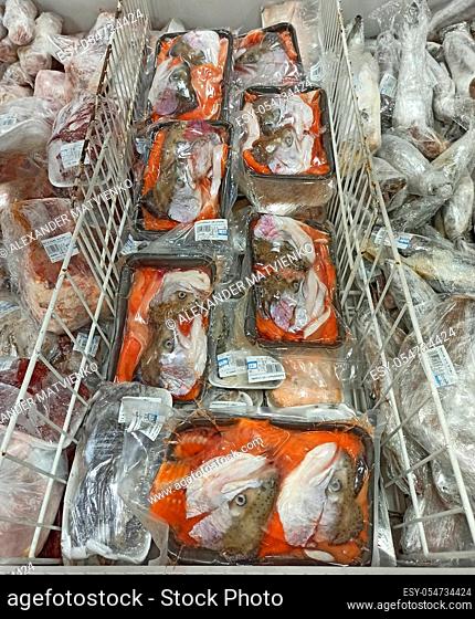 Soup set of salmon heads in supermarket refrigerator. Frozen seafood for sale. Frozen salmon in store. Food ingredients. Fresh fish and seafood