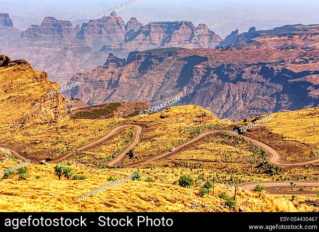 Stony winding road in Semien or Simien Mountains National Park landscape in Northern Ethiopia. Africa wilderness, Sunny morning with blue sky