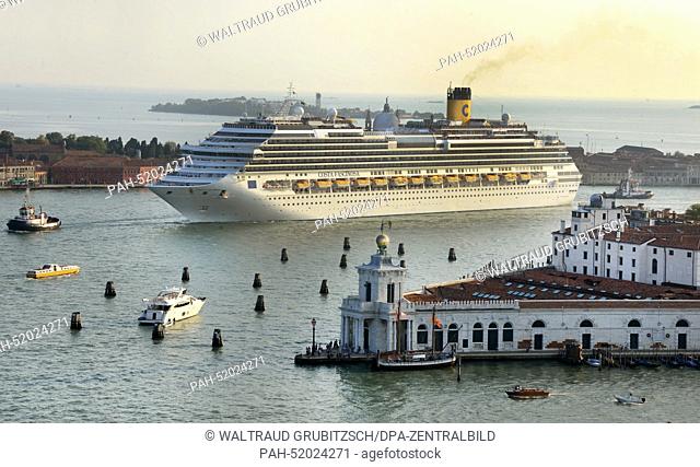 A Costa cruise ship leaves the harbour and passes close to Punta della Dogana with the church Santa Maria della Salute and the Piazza San Marco in Venice
