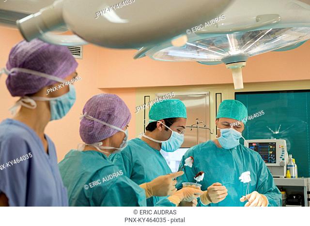 Medical team performing an operation in an operating room
