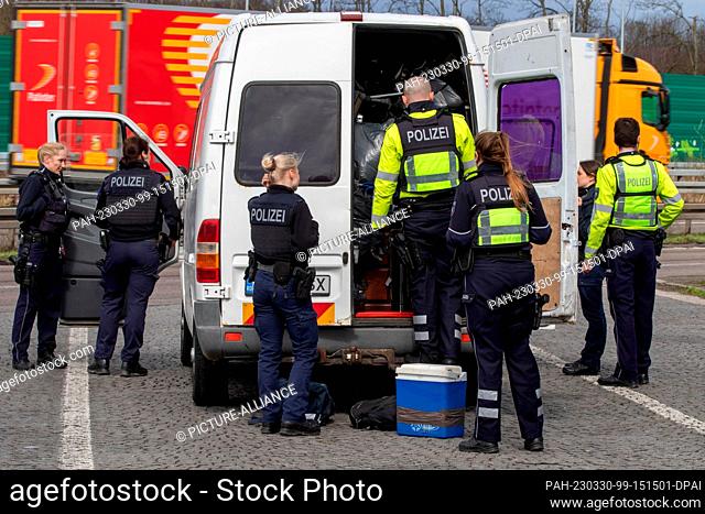 30 March 2023, North Rhine-Westphalia, Aachen: Several police officers search a white van. In the German-Dutch-Belgian border region near Aachen