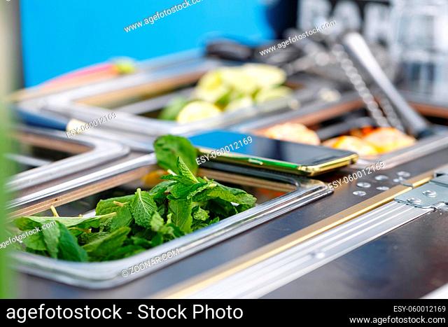Ingredients for making alcoholic summer cocktail and bar tools, drink background, top view