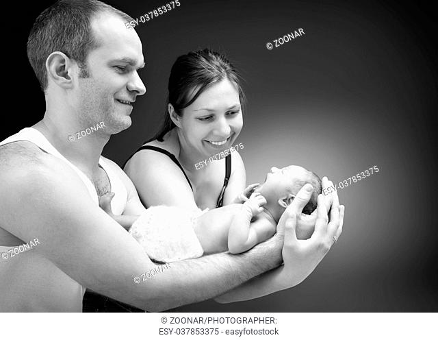 Newborn baby boy on the father's and mother's hand