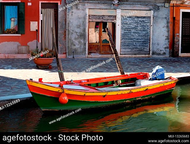 Old motorboat on the street in Burano, Italy