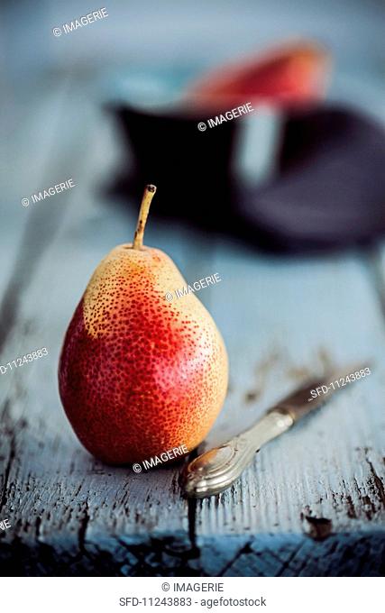 A pear on a rustic wooden table