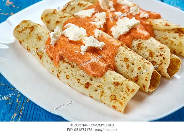 Entomatada typical Mexican dish made of a folded corn tortilla which has first been fried in oil and then bathed in a tomato sauce made from tomatoes, garlic