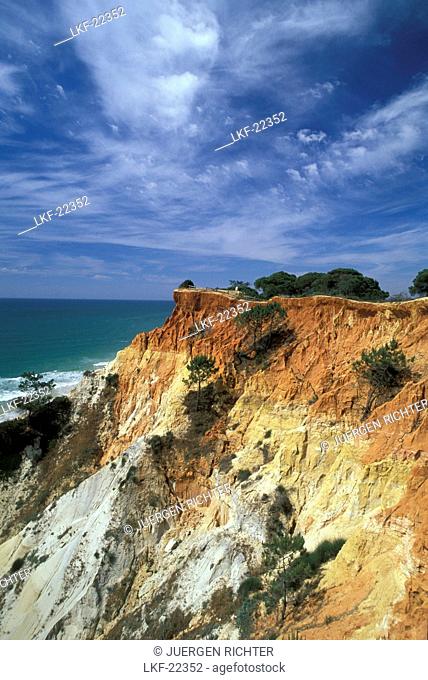 Praia da Falesia, rocky coast under clouded sky, Algarve, Portugal, Europe