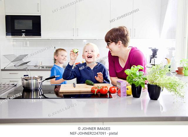 Boys preparing food in kitchen