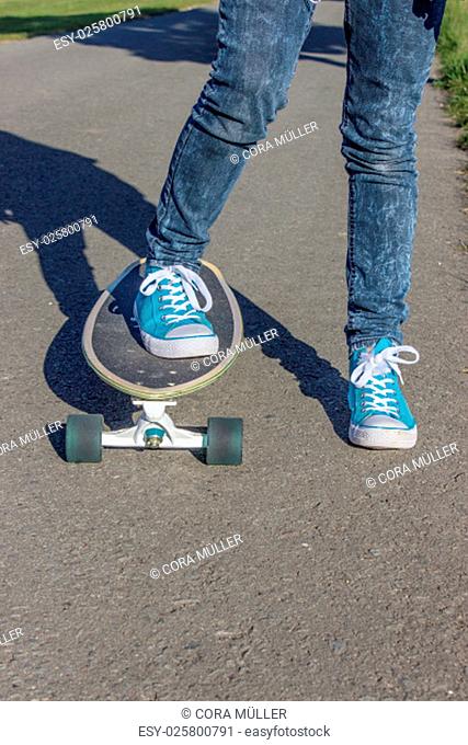 Girl with blue shoes on a skateboard