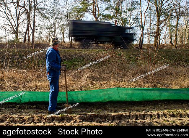 24 February 2021, Saxony-Anhalt, Jerichow: A volunteer helps to build a toad fence at the NABU district association Jerichower Land