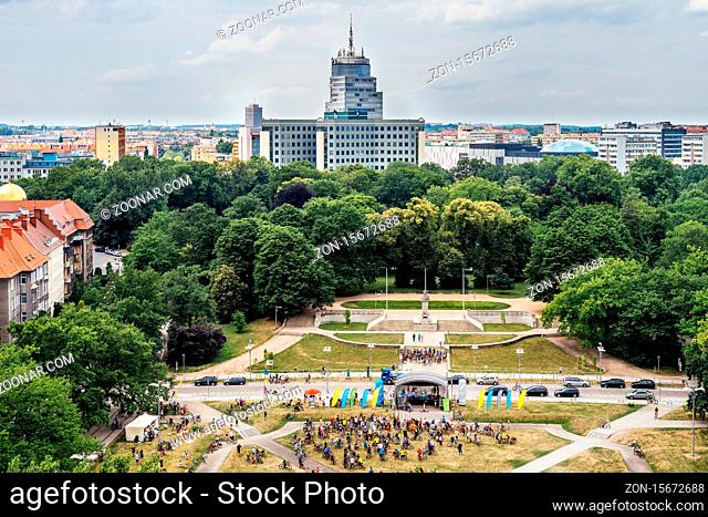 Szczecin, Poland, June 2018 Charity cycling event on Adama Mickiewicza square and city park with Radisson hotel in background