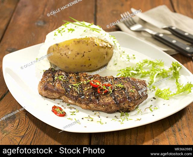 Rump steak with baked potato on square plate