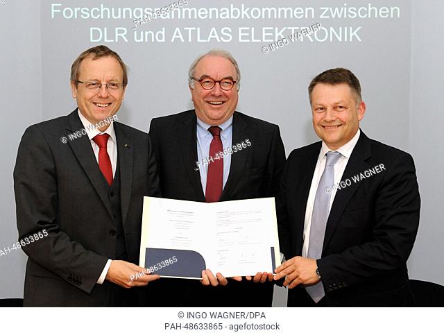 CEO of German Aerospace Center Johann-Dietrich Woerner (L-R), Secretary of State at the Ministry of Economics Uwe Beckmeyer and manager of electronics company...