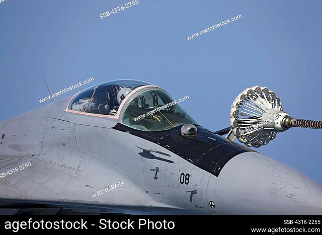 A Malaysian Air Force Mig-29 during maneuvers of its in-flight refueling probe into the 'basket' at the end of a refueling hose from a United States Marine...
