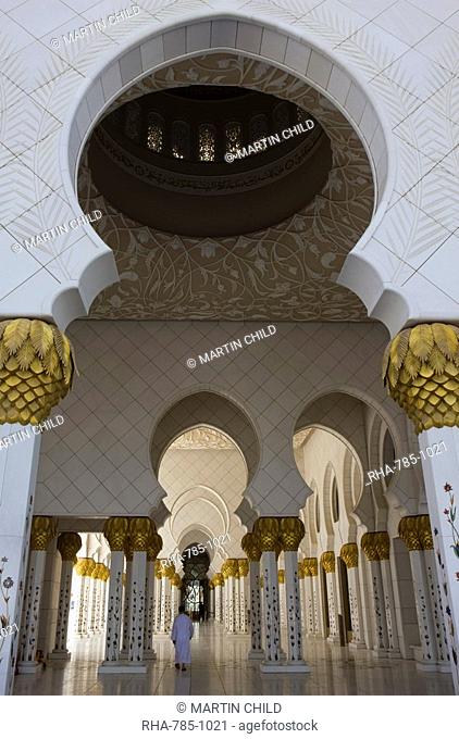 Arches and columns of the courtyard of the new Sheikh Zayed Bin Sultan Al Nahyan Mosque, Grand Mosque, lone figure, Abu Dhabi, United Arab Emirates, Middle East
