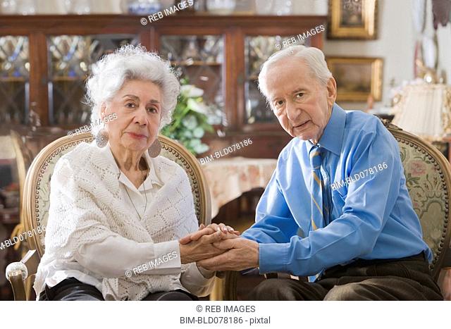 Senior Hispanic couple holding hands