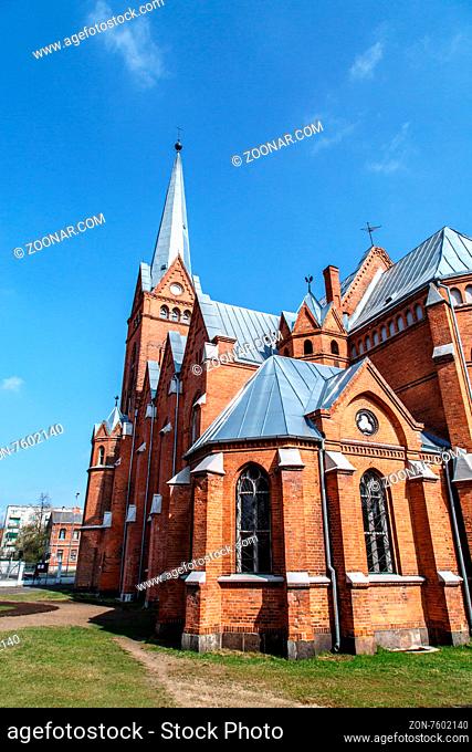 Side view of Evangelical Lutheran Marthin Luther Cathedral in Dougavpils, Latvia, on cloudy blue sky background