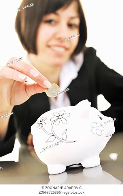 happy young business woman isolated on white puting euro money in piggy bank