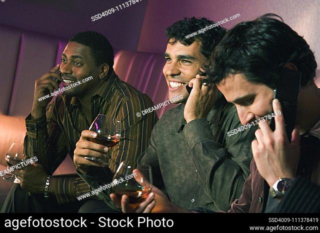 Multi-ethnic men talking on cell phones