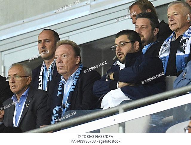 1860 Munich's president Peter Cassalette (C-L) and Jordanian investor Hasan Ismaik (C-R) watch the match from the viewing stands during the German 2nd...