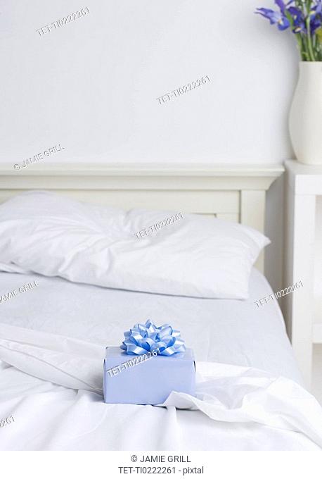 Still life of gift box on bed