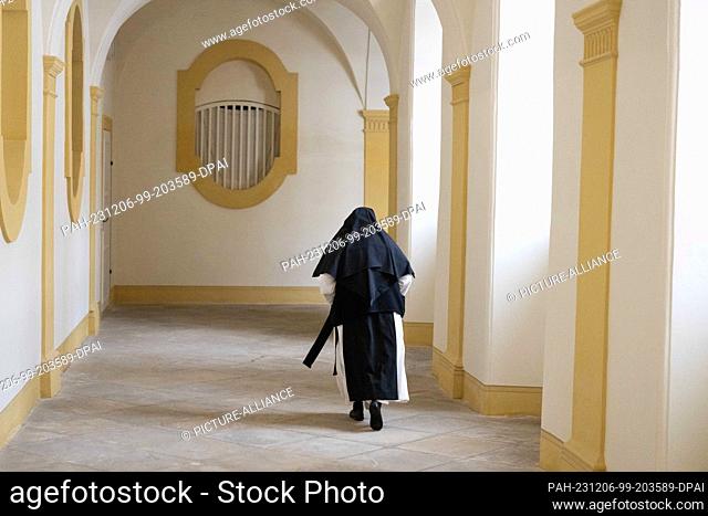 06 December 2023, Saxony, Ostritz: Elisabeth Vaterodt OCist, abbess of St. Marienthal Monastery, walks along a cloister in the monastery