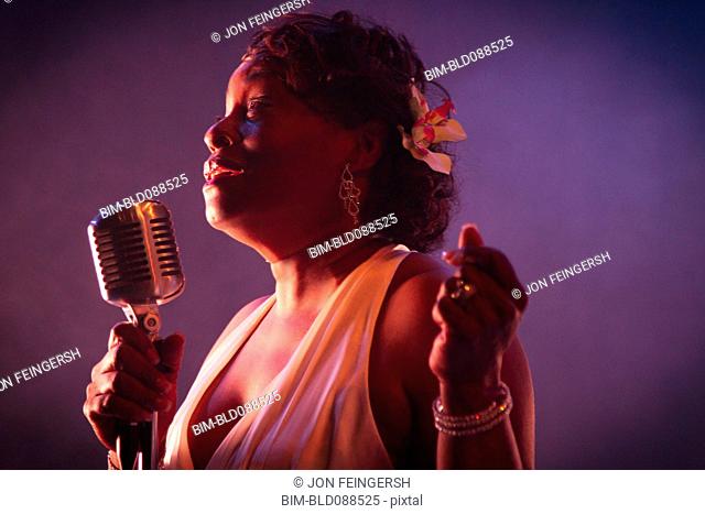 Black woman singing on stage
